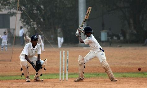 Cricket scene via Pixabay Wicketkeeper, stumps, batter and cricket ball.