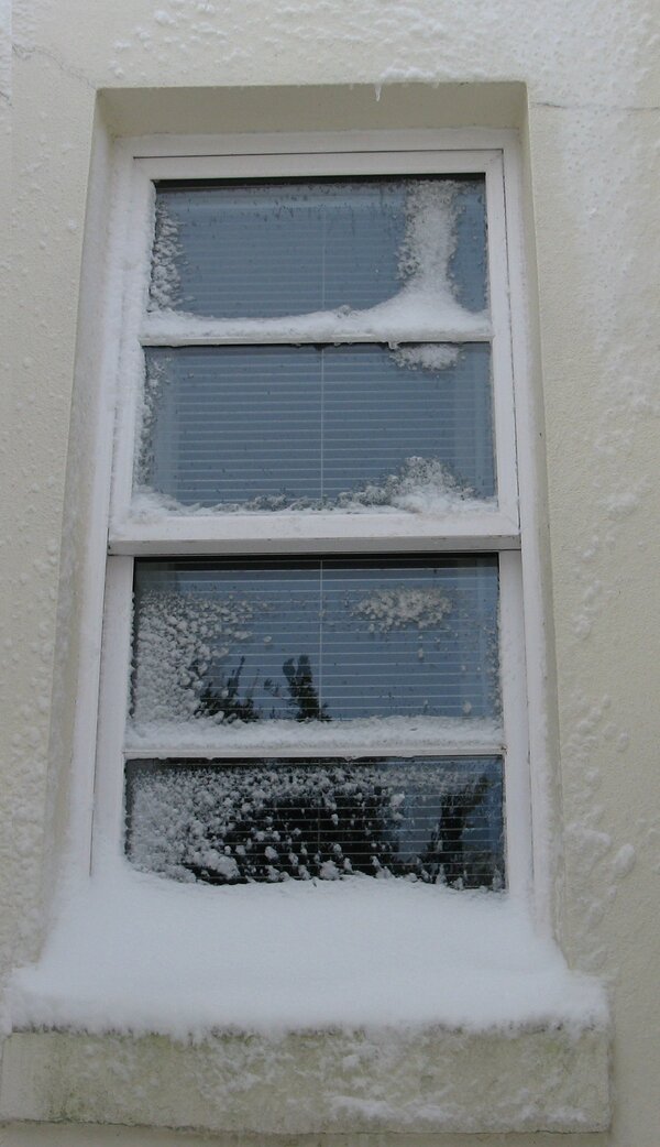 Photo (c) J.G. Betts Sah window with snow on glazing bars and sill