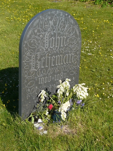 Sir John Betjeman's grave St Enodoc's church Cornwall. (Dark stone)
