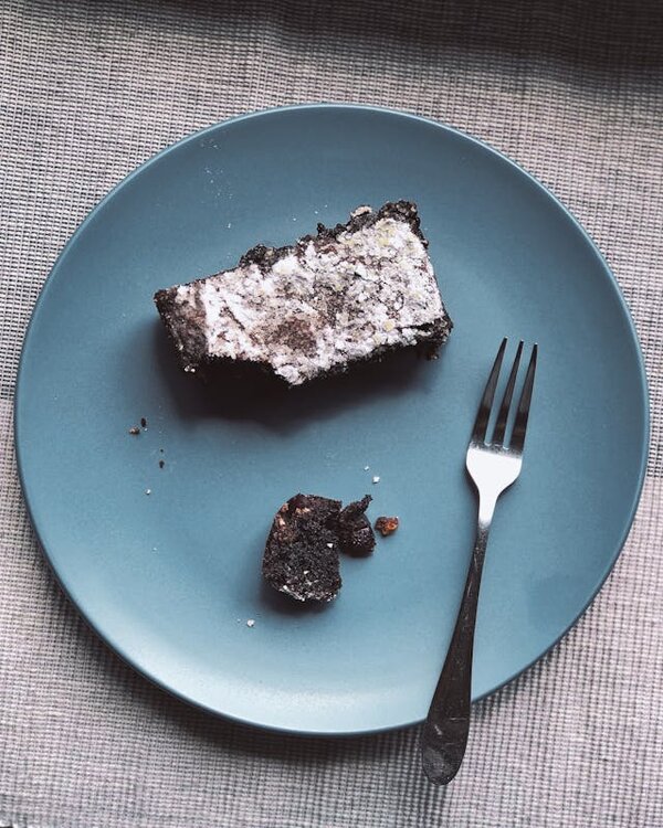 Photo by Flat Hito via Pexels Slice of chocolate cake on blue plate