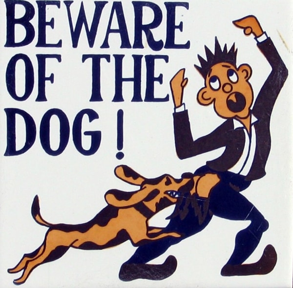 Dog biting man on ceramic plaque